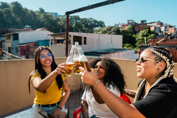 istock Friends women talking and toasting beer at rooftop 2166629545