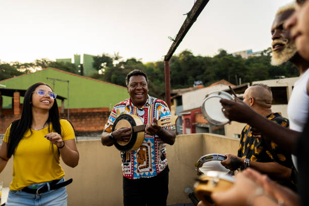 istock Friends singing and playing instruments during party at rooftop 2166629853