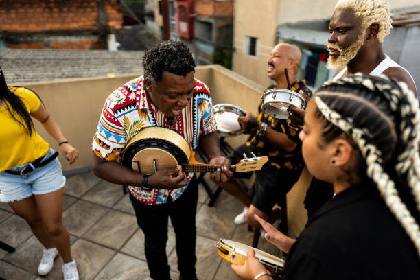 istock Friends singing and playing instruments during party at rooftop 2166629861