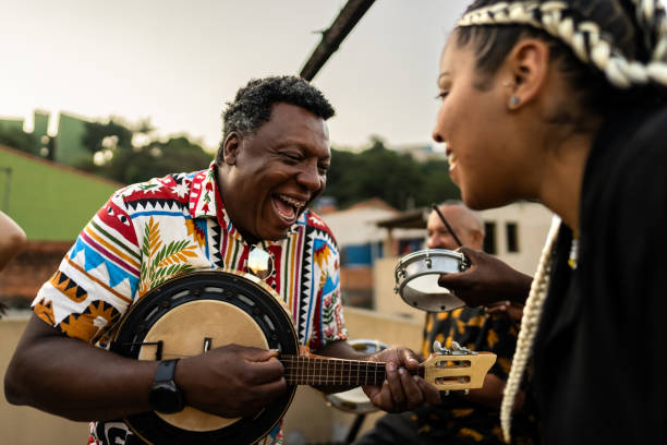 istock Friends singing and playing instruments during party at rooftop 2166629871