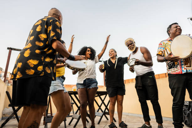 istock Friends dancing and playing instruments on rooftop party 2166629907