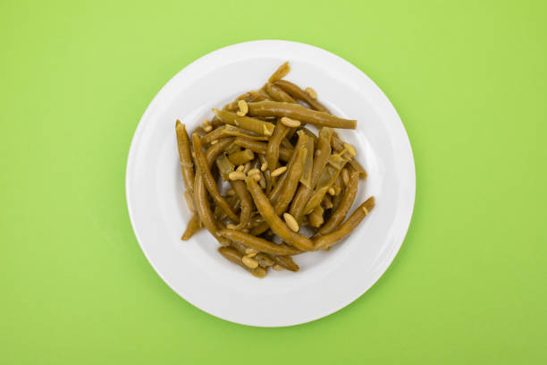 Boiled green beans on white plate
