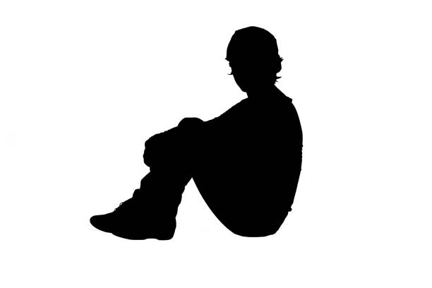 Dark silhouette of a young woman on a white background side view.