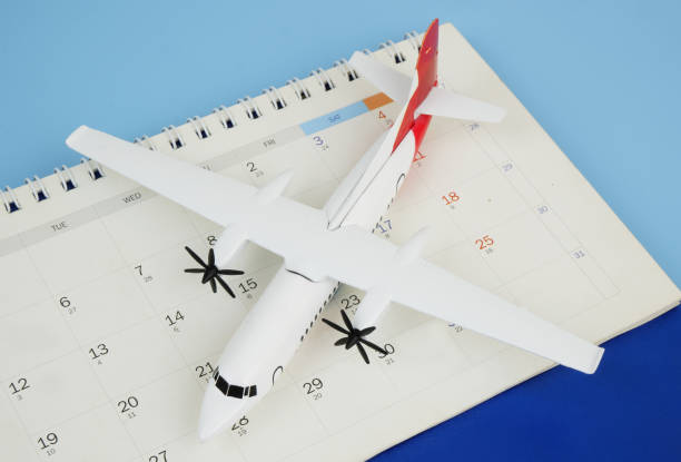 istock Airplane model on calendar on blue background. 2166632658