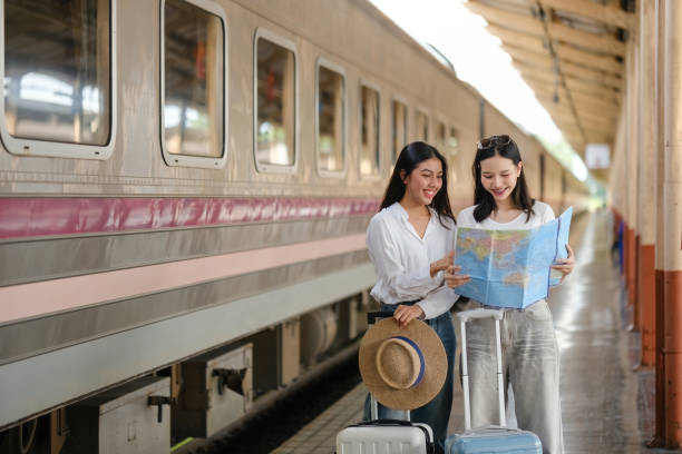 istock Two women are looking at a map while waiting for a train 2166633220