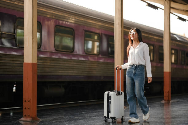 istock A woman is walking with a suitcase at a train station 2166633267