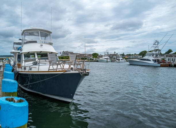 Photos of distinctive yachts moored at the mouth of Falmouth Harbor in Falmouth, MA on Cape Cod.  The man-made harbor is particularly busy during the warm summer months.  It feeds in to Vineyard Sound and leads in to the Atlantic Ocean.