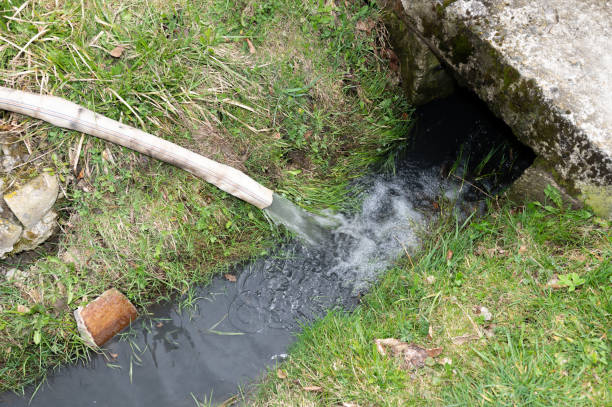 istock Water flows into the ditch from a hose. 2166638064