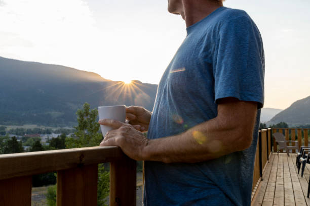 istock Mature man enjoys cabin veranda 2166639263