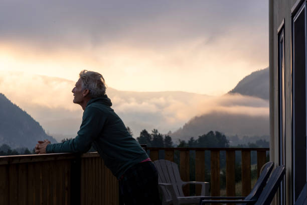 istock Mature man enjoys cabin veranda 2166639397