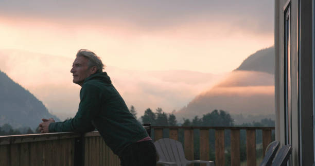 Mature man enjoys cabin veranda