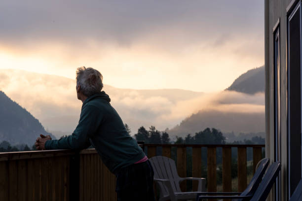 istock Mature man enjoys cabin veranda 2166639408