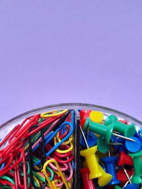 istock Paper clips with purple background 2166640426