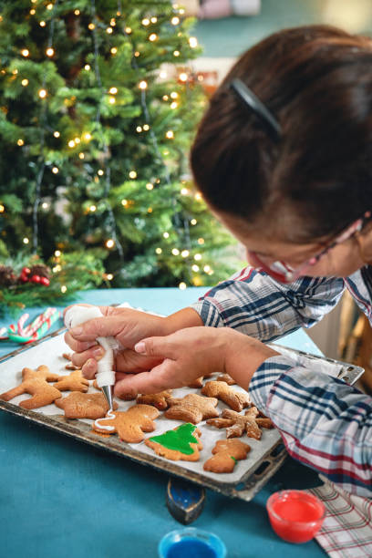istock Decorating Gingerbread Christmas Cookies with Icing 2166641255