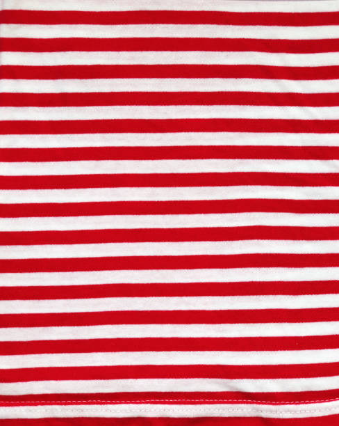 istock Red and white style striped fabric texture. Background with  striped closeup weave fabric. Pinstripe material of red and white color 2166646095
