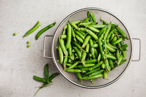 istock Fresh green peas in pods. 2166649749