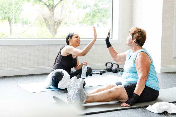 istock Senior woman gets high five from female personal trainer 2166649785