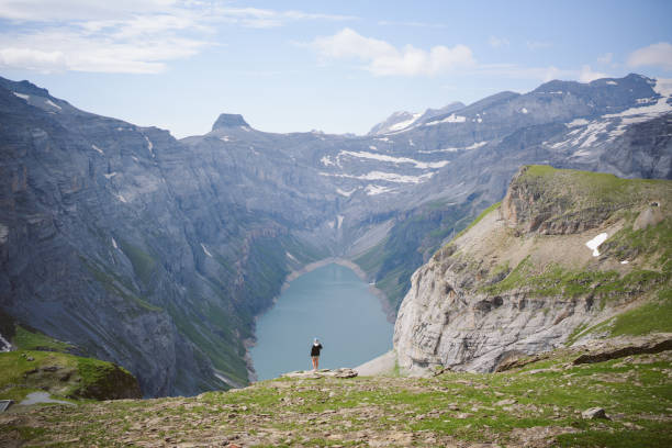 Hiker in foreground. Limmernsee hike in Tierfehd, Swiss Alps