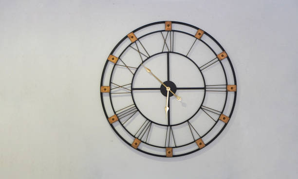 istock front view black gold wall clock hanging on a white wall, object, decor, decoration, fashion, gift, luxurious, beautiful, magnificent, copy space 2166652478