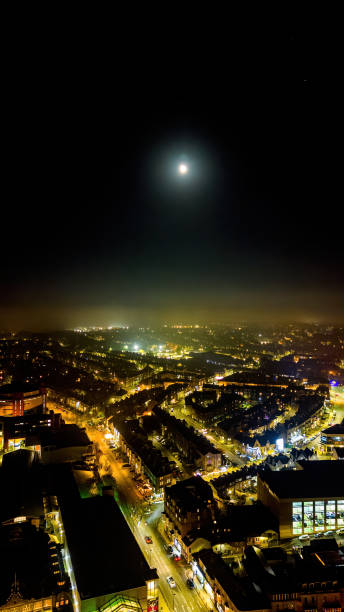 istock Nighttime cityscape with bright moon over illuminated streets and buildings 2166653816