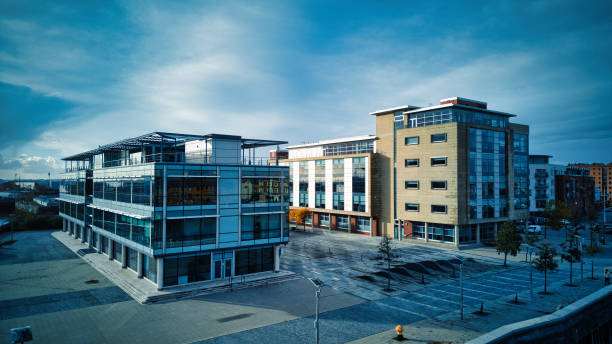 istock Modern office buildings with glass facades under cloudy sky 2166658086