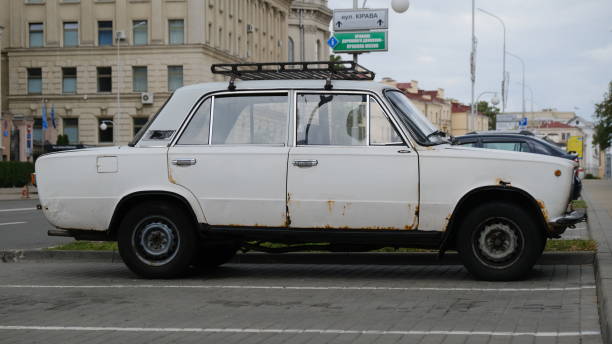 istock An old white rusty car parked  in a city 2166659331