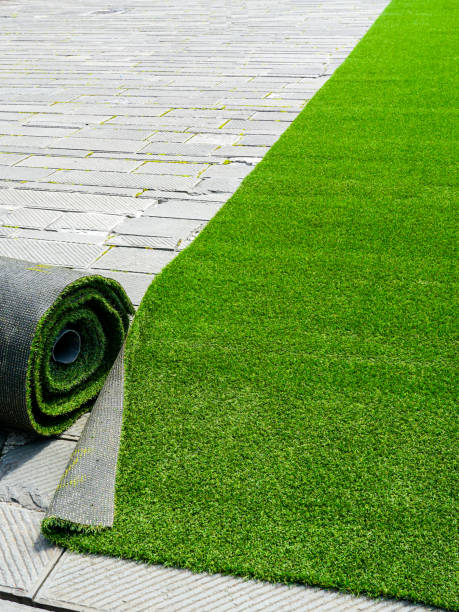 istock Preparing artificial grass carpet rolls for outdoor event flooring in the town square 2166660213