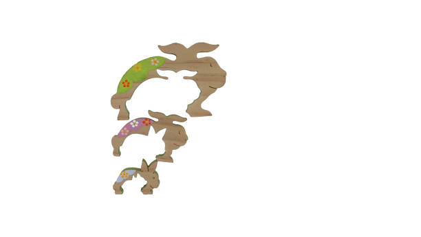 Disassembled wooden rabbit puzzle on white background.