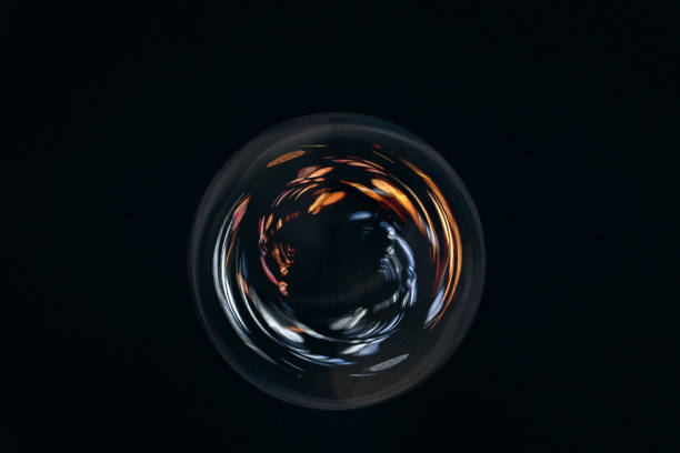 Abstract reflection in glass orb against dark background
