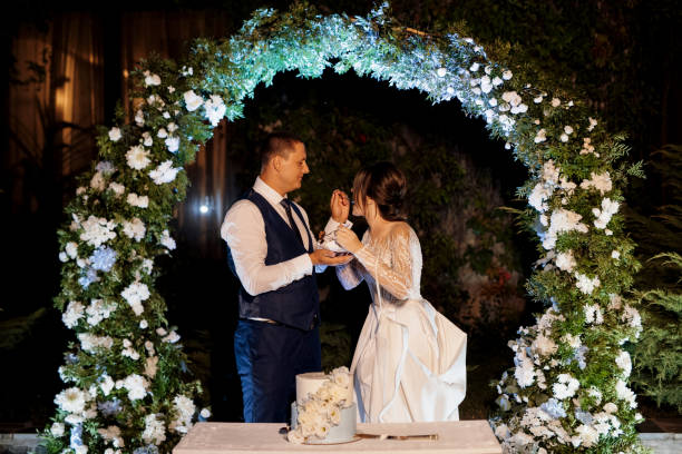 istock newlyweds happily cut and taste the wedding cake 2166662524