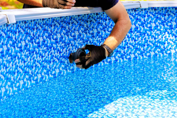 istock Chlorination water filtration system installed in swimming pool frame by a worker 2166662836