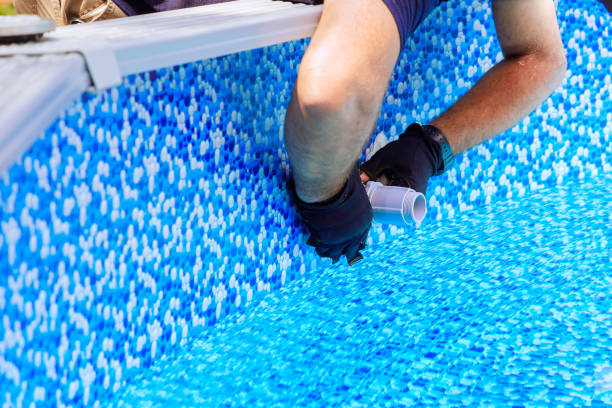 istock Maintenance worker installs water filtration system, chlorination system in a frame swimming pool 2166662851