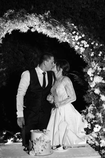 istock newlyweds happily cut and taste the wedding cake 2166664889
