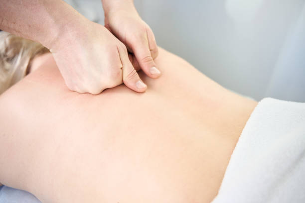istock Masseur giving upper back massage to client 2166665145