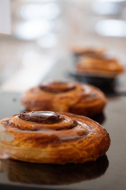istock Close-up of cinnamon rolls with icing on a serving tray 2166667813