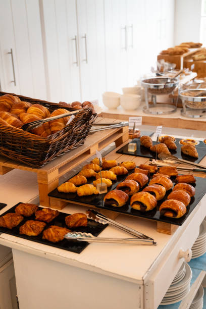 Variety of freshly baked pastries on display at a breakfast buffet