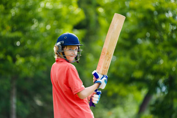 istock Kids playing cricket in summer park 2166667972