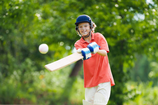 istock Kids playing cricket in summer park 2166668049
