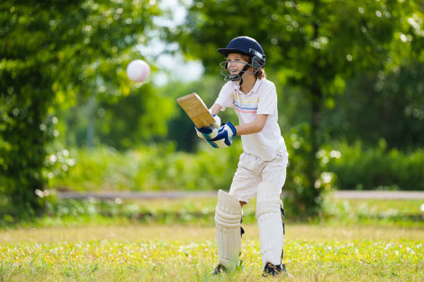 istock Kids playing cricket in summer park 2166668081