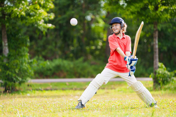 istock Kids playing cricket in summer park 2166668197