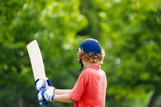 istock Kids playing cricket in summer park 2166668228