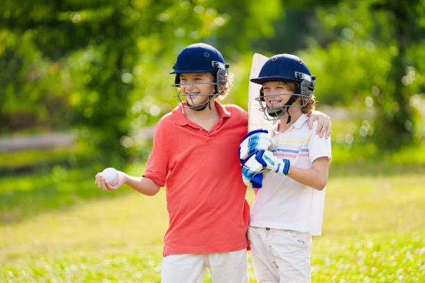 istock Kids playing cricket in summer park 2166668280