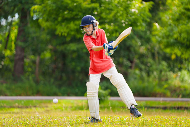 istock Kids playing cricket in summer park 2166668291