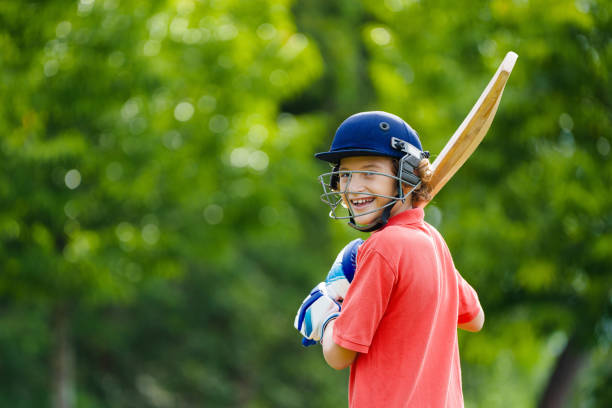 istock Kids playing cricket in summer park 2166668482