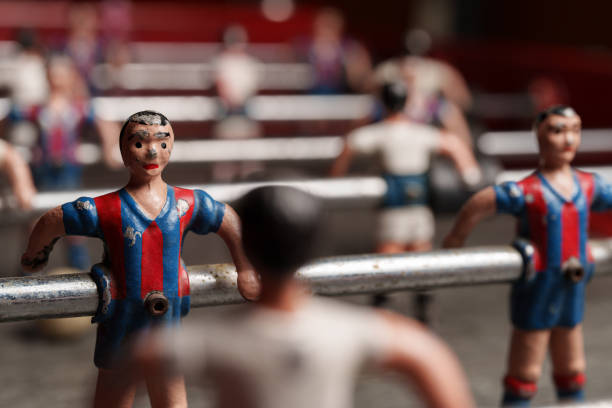 Detail of a metal player worn by time on an old football table