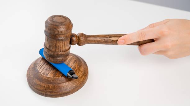 istock Judge hammering disposable vape with referee's gavel on white table. 2166673063