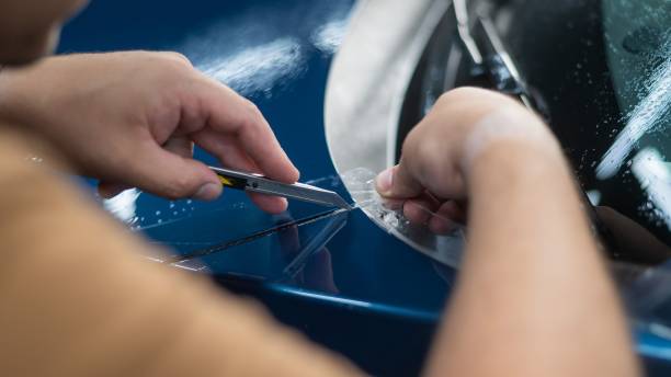istock The master in the car service cuts the protective cutter. 2166673297