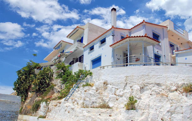 istock Traditional Greek architecture with white houses, blue doors and shutters 2166673352