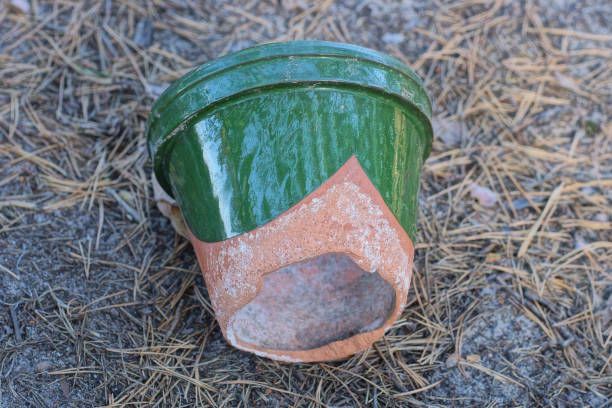 istock one old broken ceramic green brown pot with a knocked out bottom 2166673368
