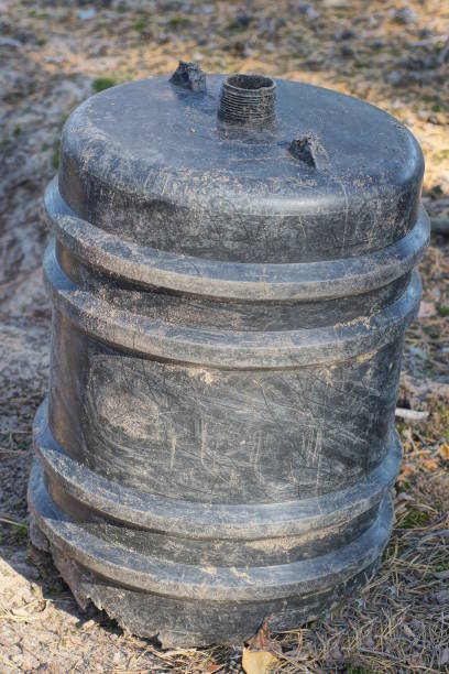 istock one old plastic black bottle barrel stands on the ground 2166673374